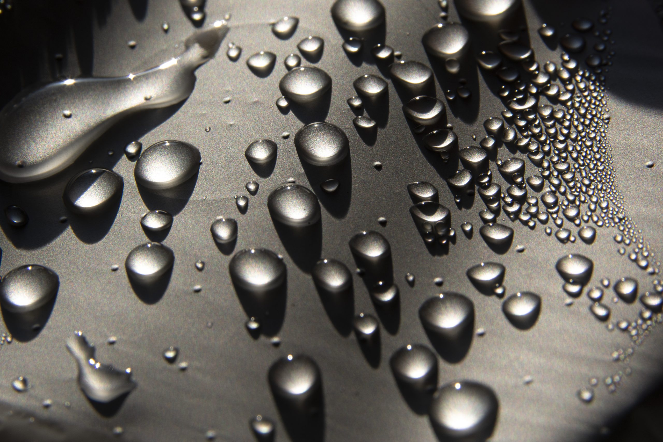 A closeup shot of water drops on a car