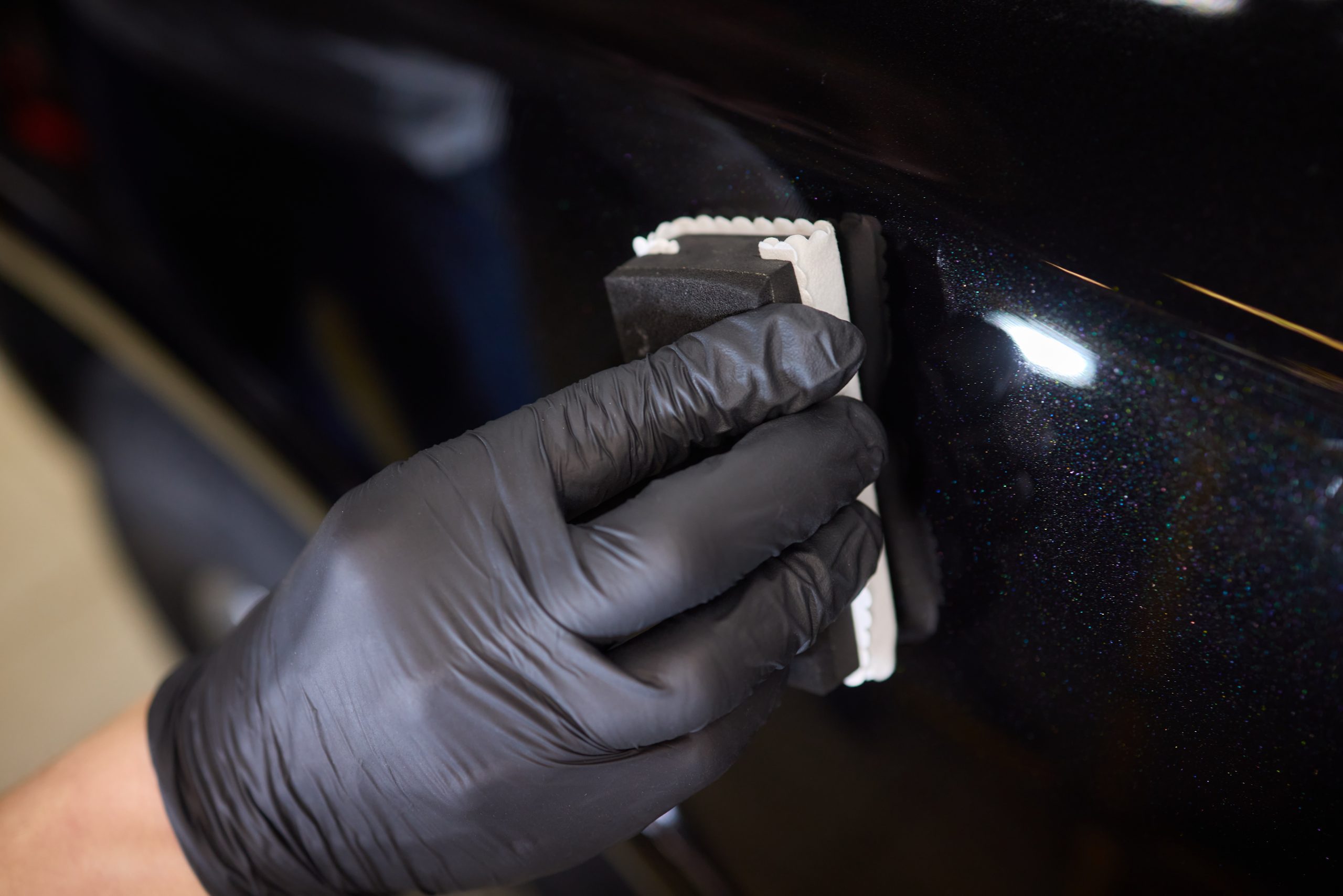ng ceramic coating to car using sponge. Professional car detailing